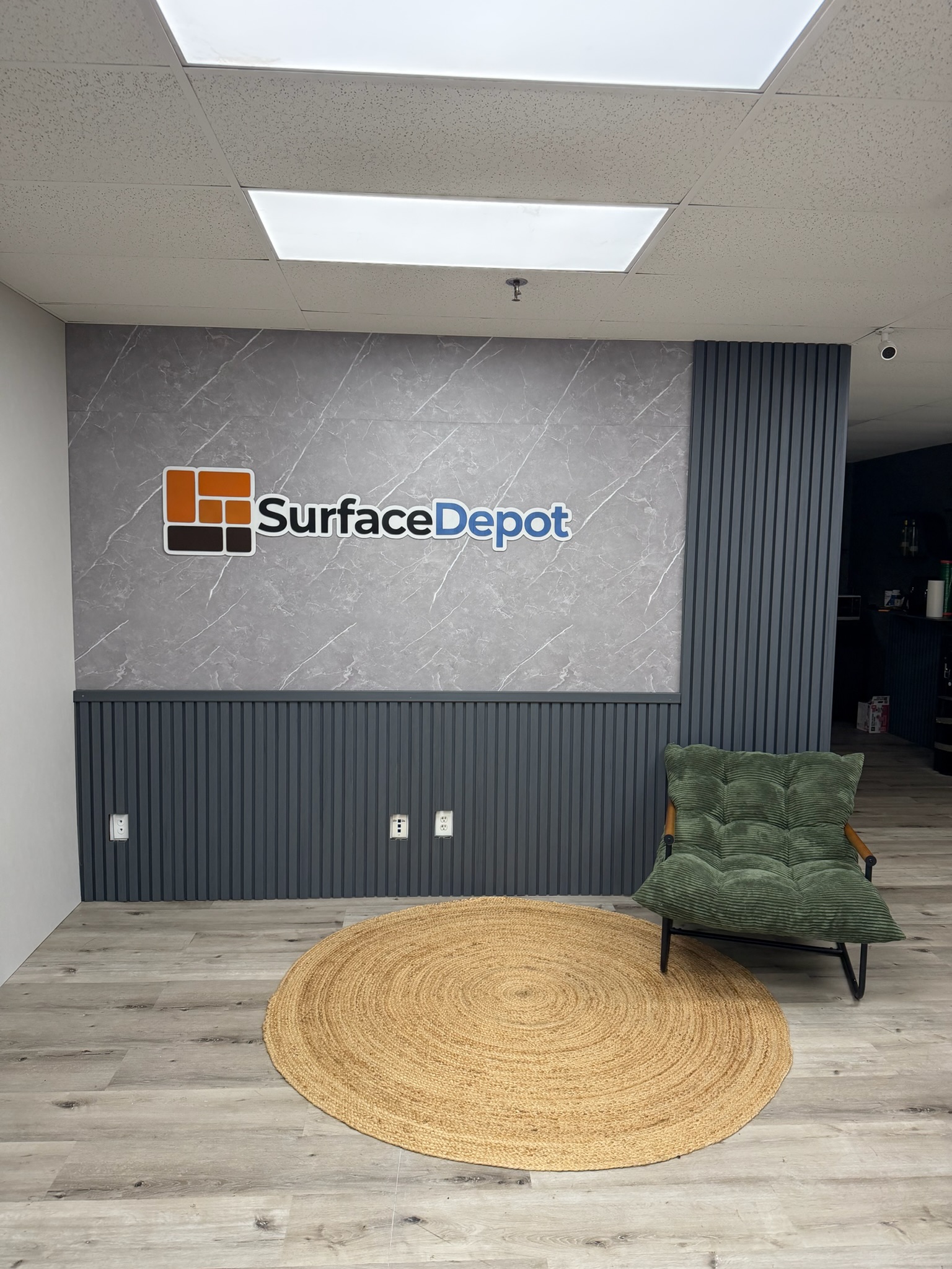 Surface Depot showroom lobby featuring Grey Acoustic Wall Panels and Bamboo Veneer Board