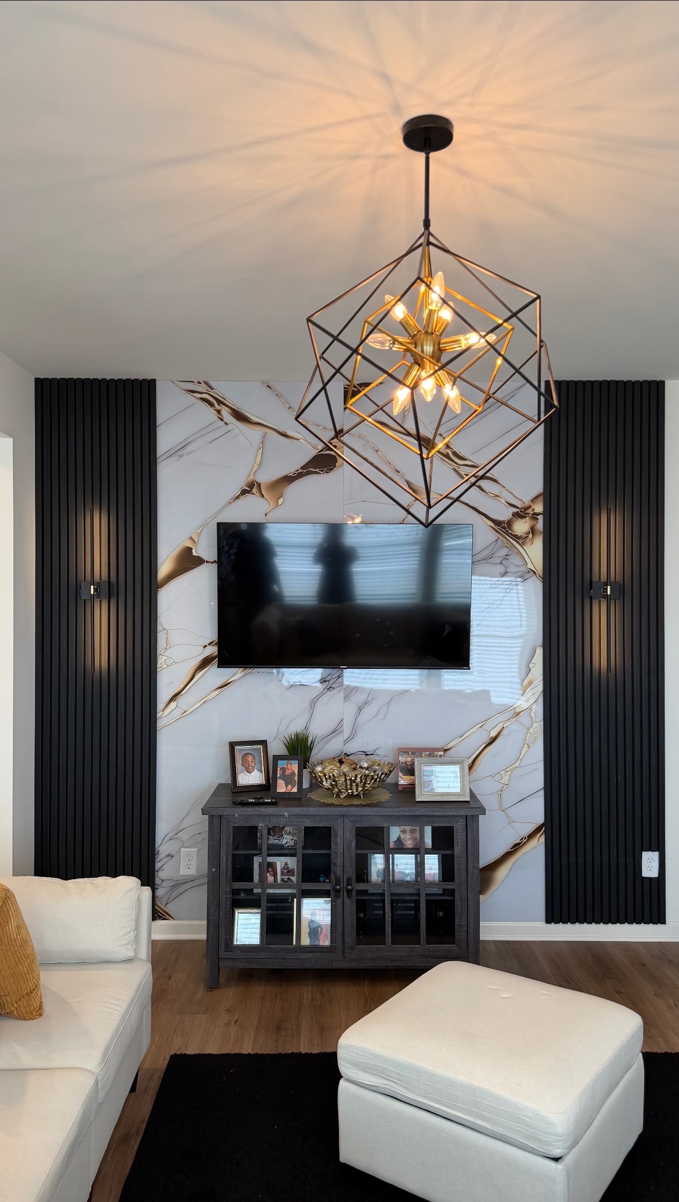 Den renovation accent wall with Black Acoustic Panels flanking a gold-veined Marble Sheet